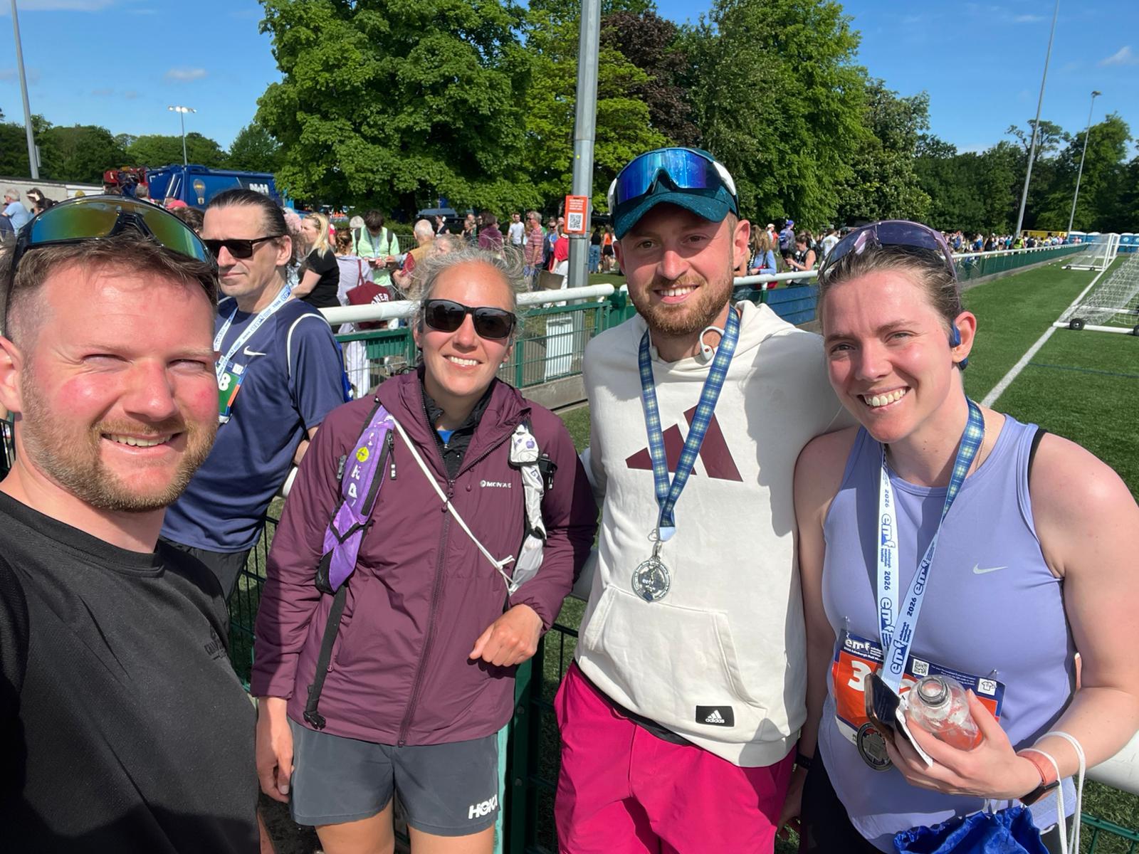 Tri Project members with medals after a race